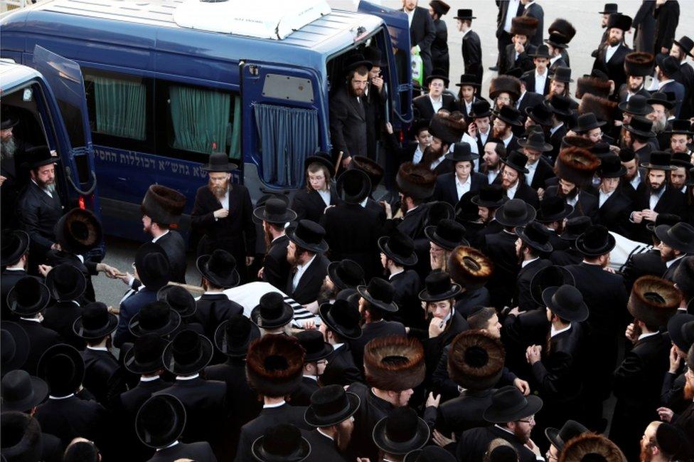 Ultra-Orthodox Jewish men gather at the funeral of Moshe Engerld and his brother Yehoshua