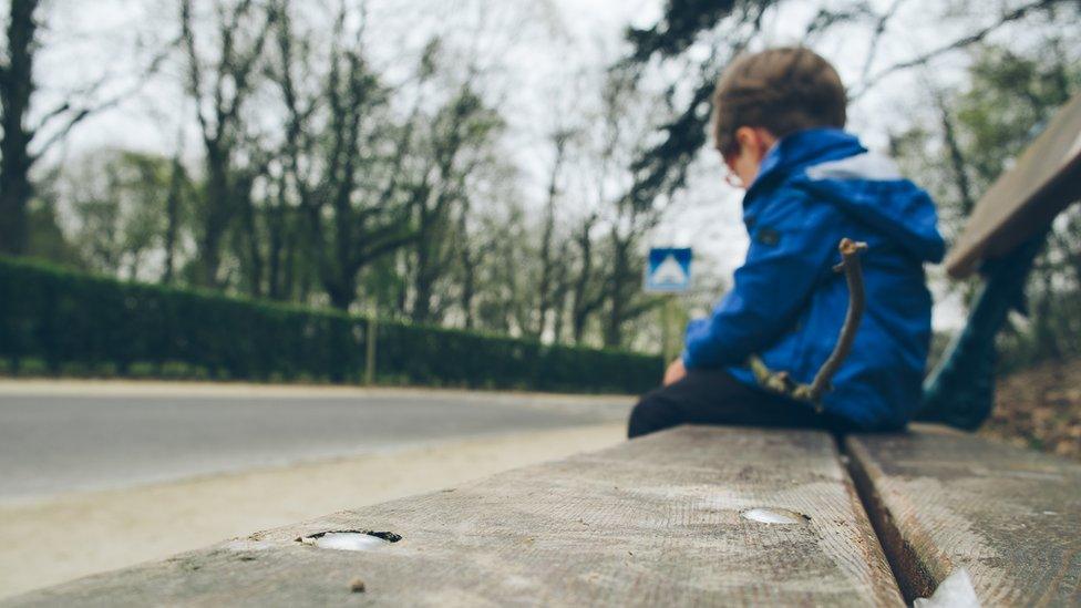 child-sitting-on-bench