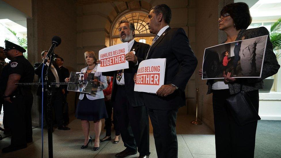 California Congresswoman Lucille Roybal-Allard holds a photo of the image at a protest at Capitol Hill outside Mr Trump's meeting with Republicans on Tuesday