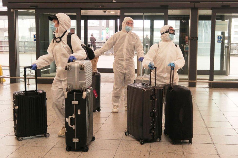 Passengers determined to avoid the coronavirus before leaving the UK arrive at Gatwick Airport departure area.