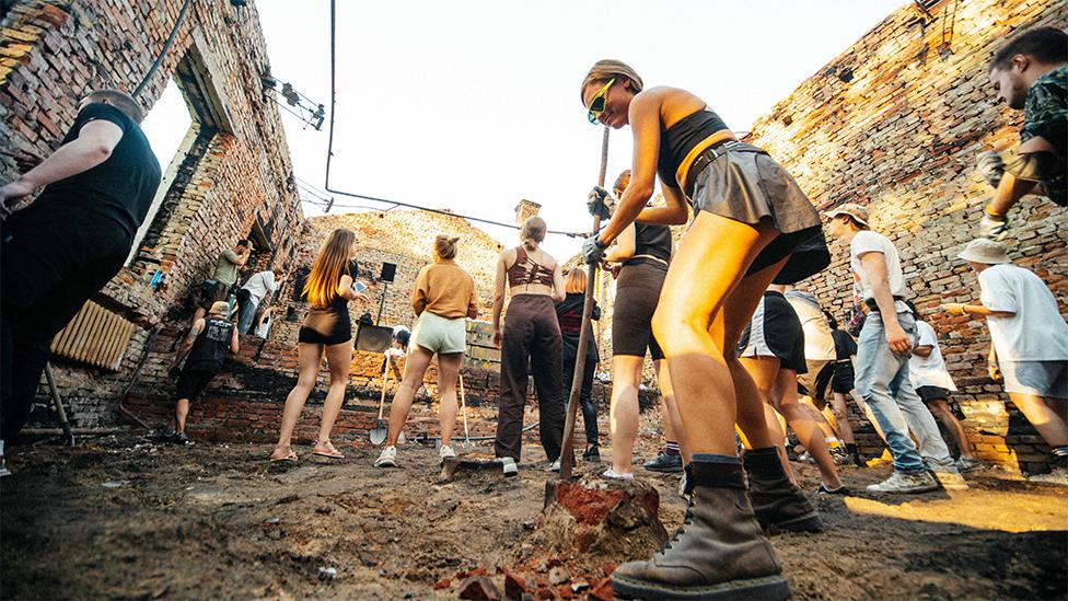 People cleaning up rubble