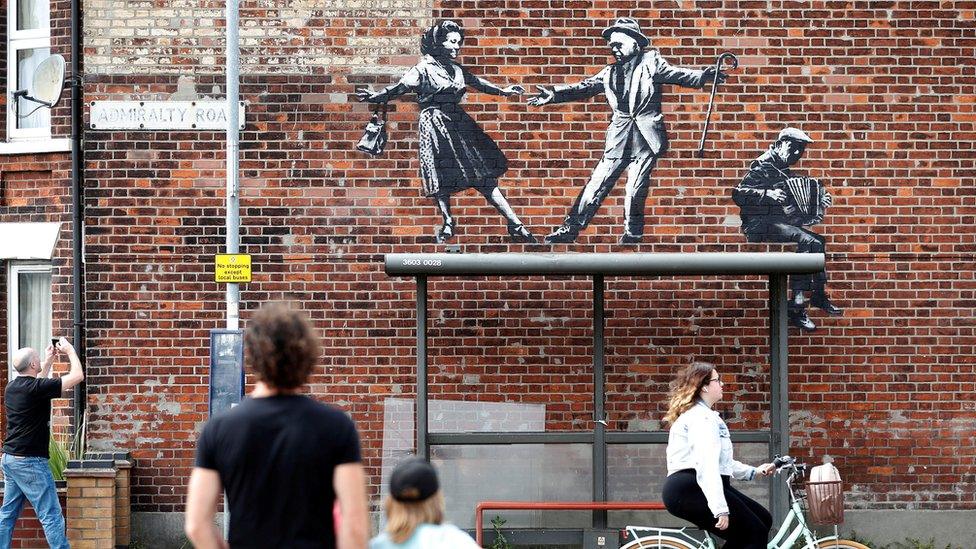 People stop to look at artwork believed to be created by Banksy in Great Yarmouth