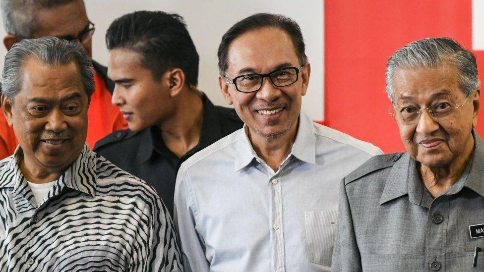 Malaysia's Mahathir Mohamad (R), politician Anwar Ibrahim (C) and Affairs Muhyiddin Yassin