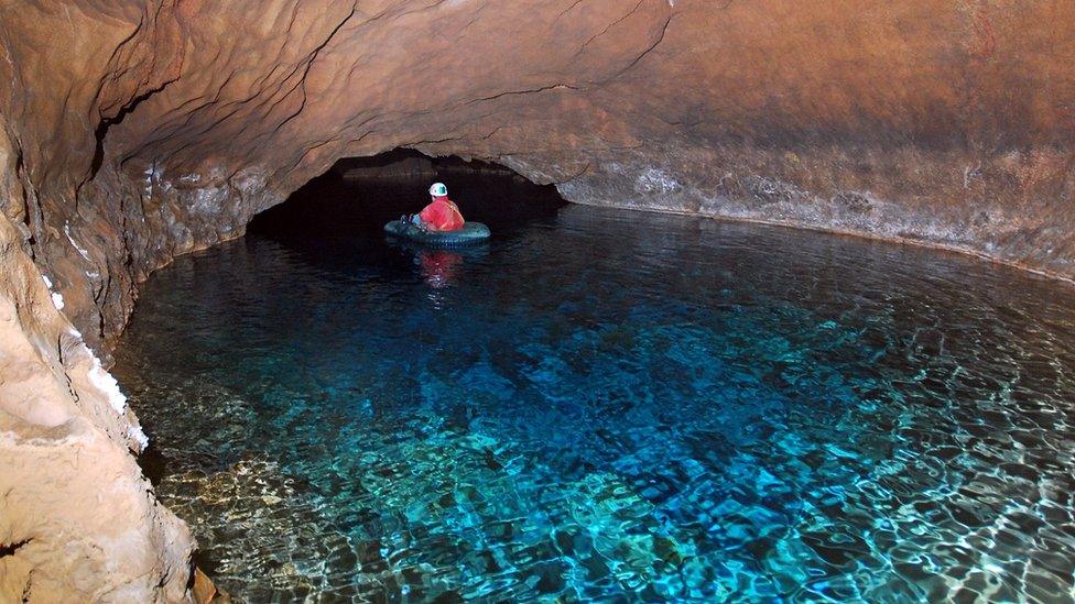 A rescuer explores a cave system in Germany 2014