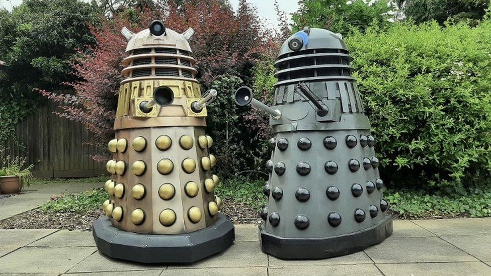 One gold and one grey Dalek