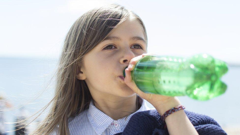 Girl drinking a sugary drink