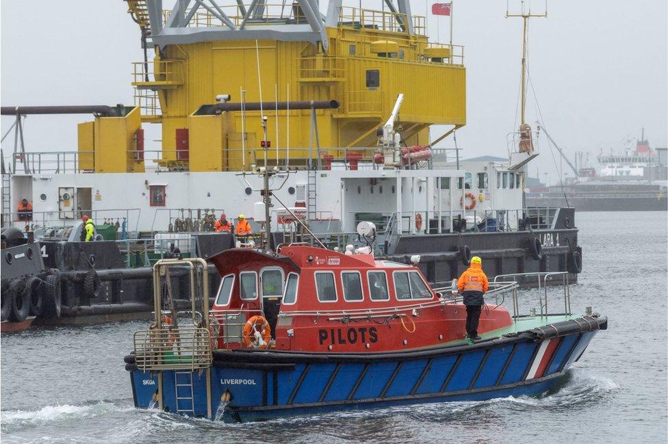 Salvage teams at Victoria Harbour ahead of recovering a tugboat from the water in the Firth of Clyde, near Greenock