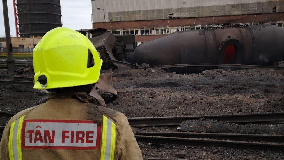 A fireman assesses the damage on the site