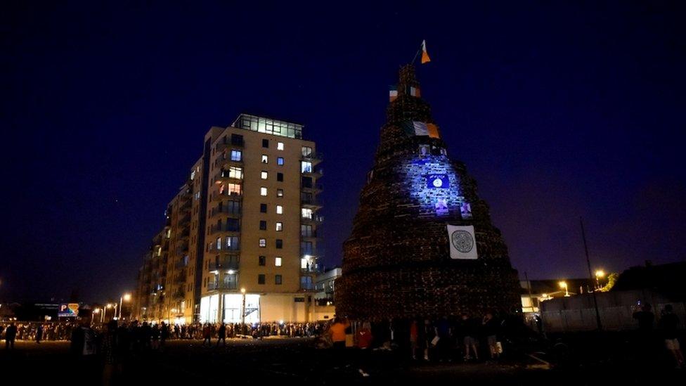 The bonfire is pictured before the burning, with the apartment building behind