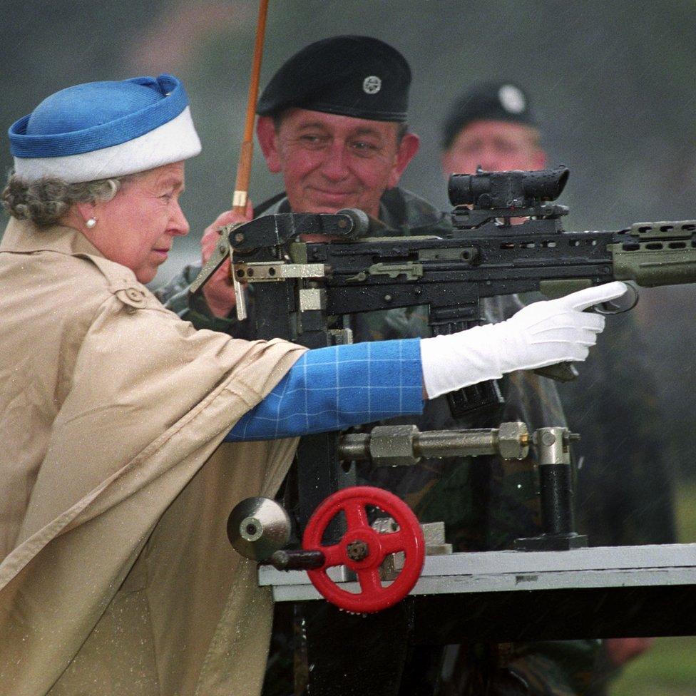 Queen Elizabeth II, with Chief Instructor, firing a standard SA 80 rifle