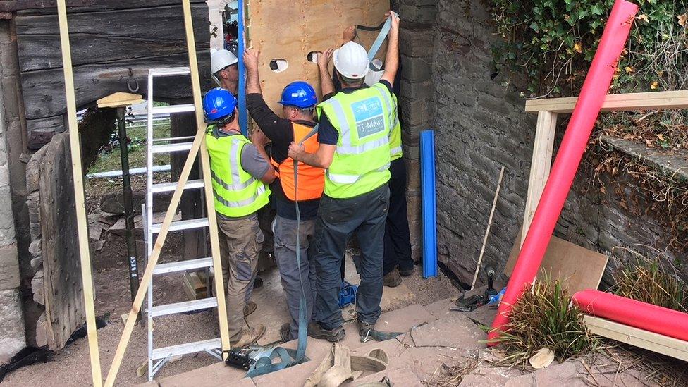 Workmen start the task of dismantling the gate