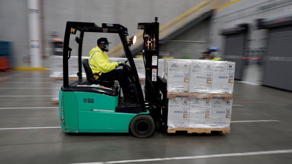 man in forklift delivering vaccines.