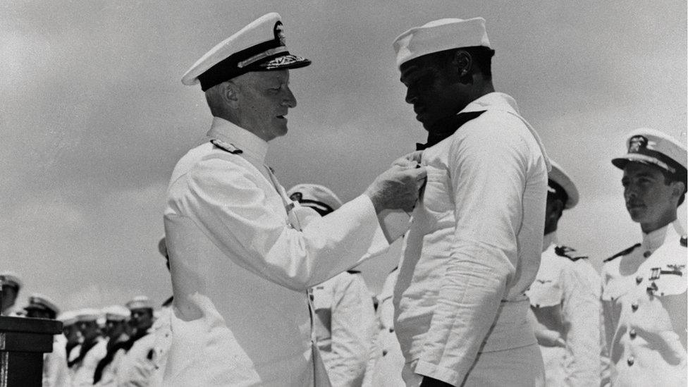 Admiral Chester W Nimitz, left, pins the Navy Cross on Doris Miller