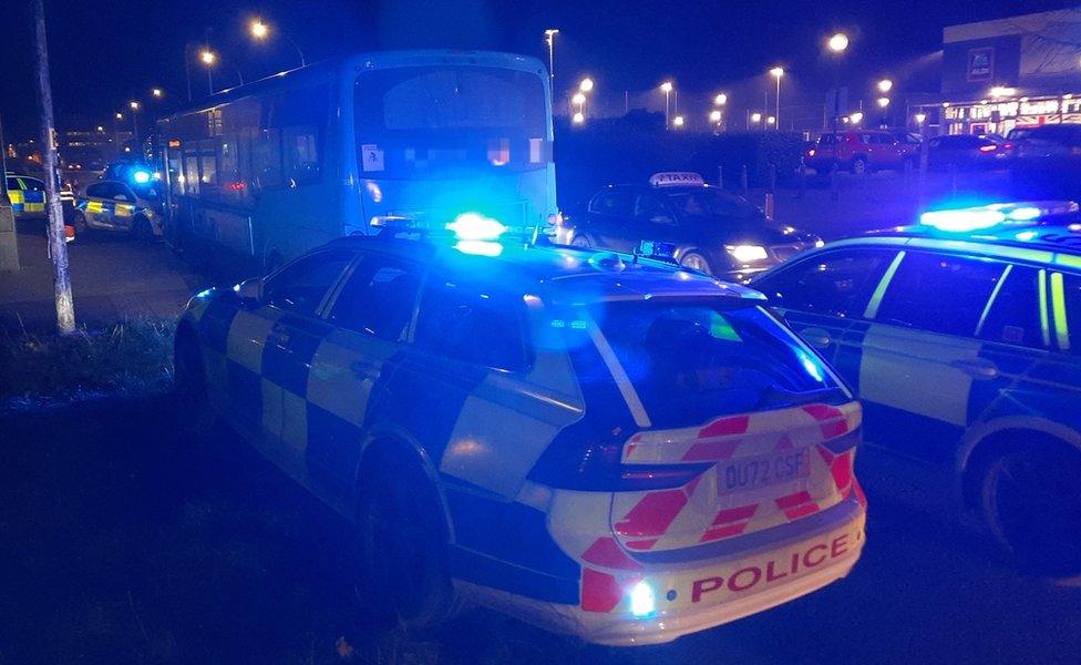 The stolen bus surrounded by police cars in Milton Keynes