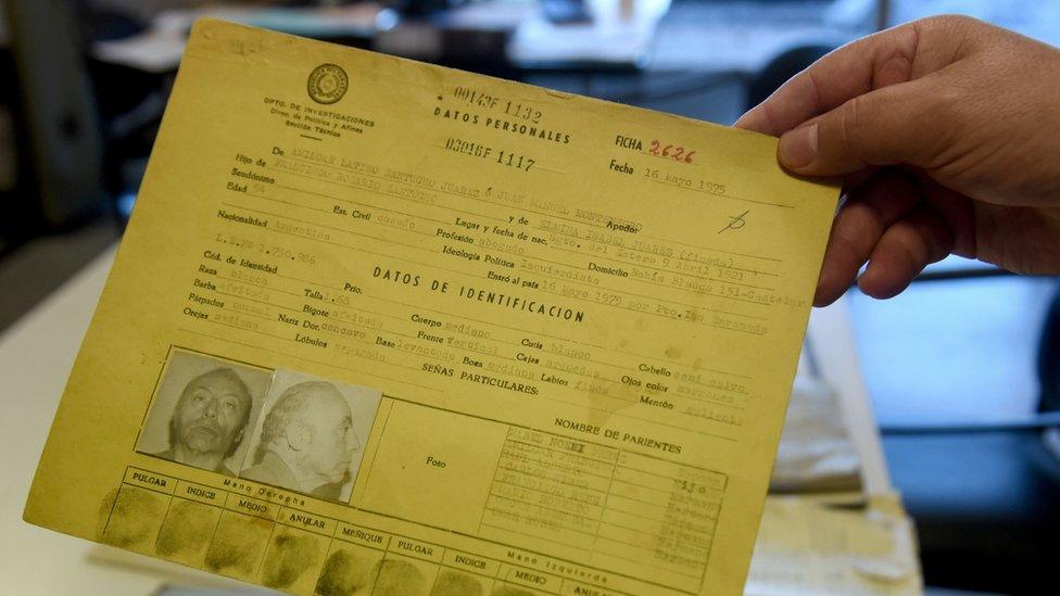 Paraguayan Judge Agustin Fernandez, director of the Documentation and Archive Center for Human Rights Defense, shows some of the documents that form part of the "Archives of Terror", at the Justice Palace in Asuncion, on January 16, 2019. -