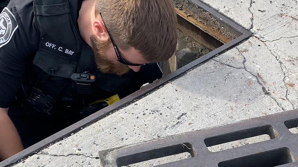 Police officer in drain
