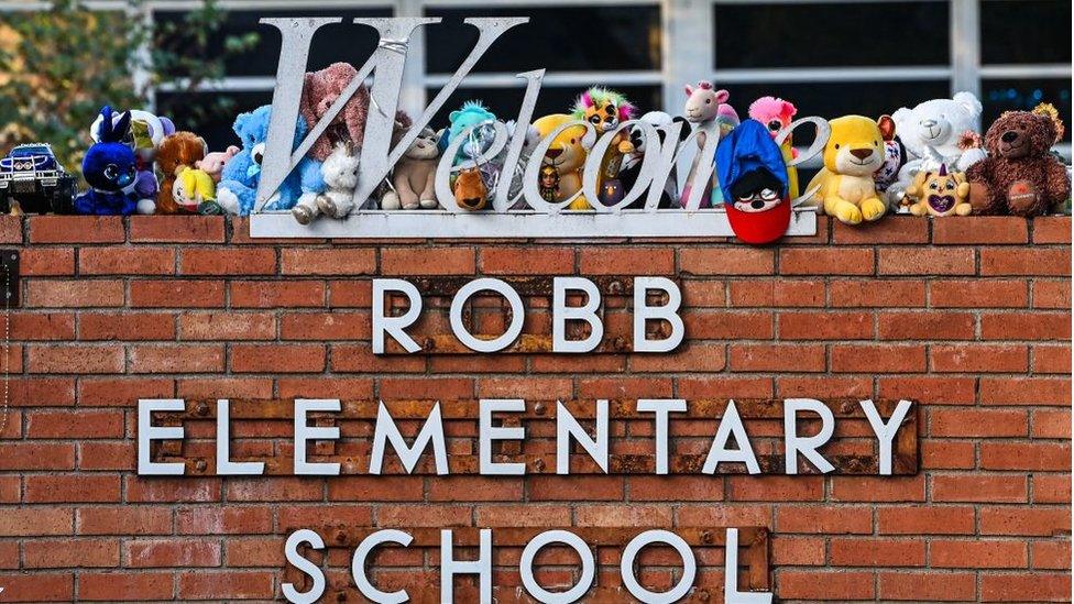 Mementos decorate a makeshift memorial for the shooting victims outside Robb Elementary School in Uvalde, Texas