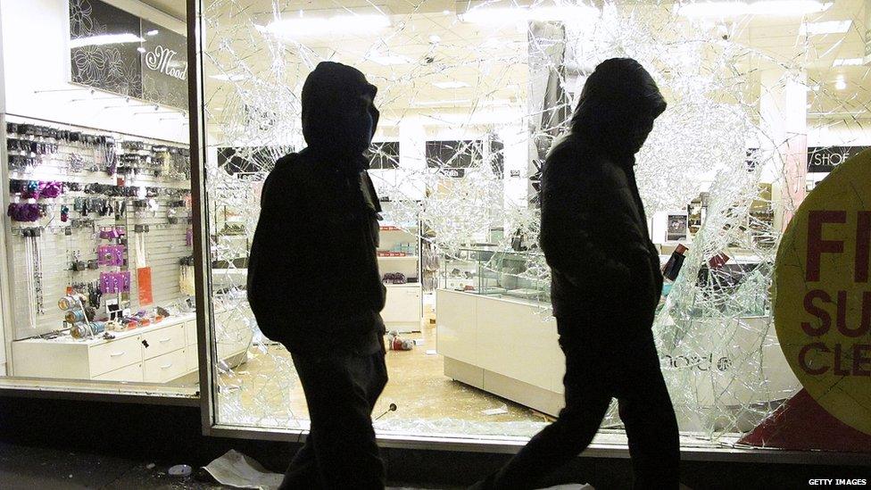 Two youths with their faces covered during the 2011 riots