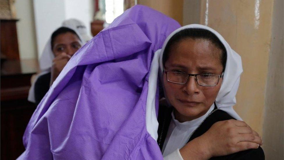 A woman afraid of pro-government Sandinista youths embraces a nun as she takes shelter at the San Sebastian Basilica in Diriamba, Nicaragua, on July 9, 2018.