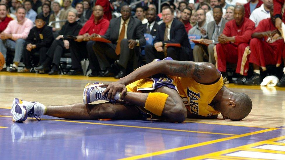 Kobe Bryant lies injured at a game.