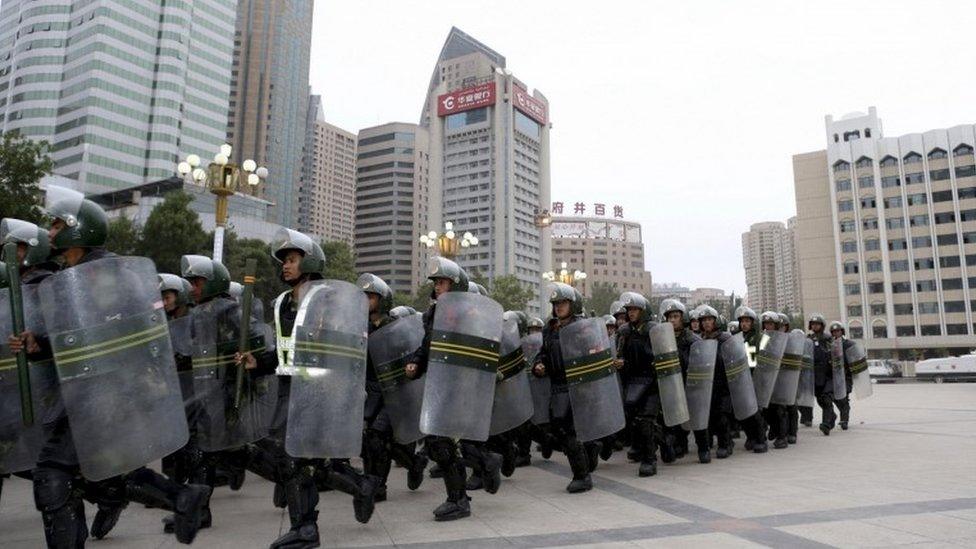 Armed paramilitary policemen run in formation during a gathering to mobilize security operations in Urumqi, Xinjiang Uighur Autonomous Region, in this June 29, 2013 file photo.