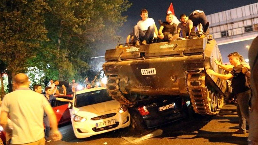 People on a tank run over cars on a road in Istanbul, Turkey, 16 July 2016