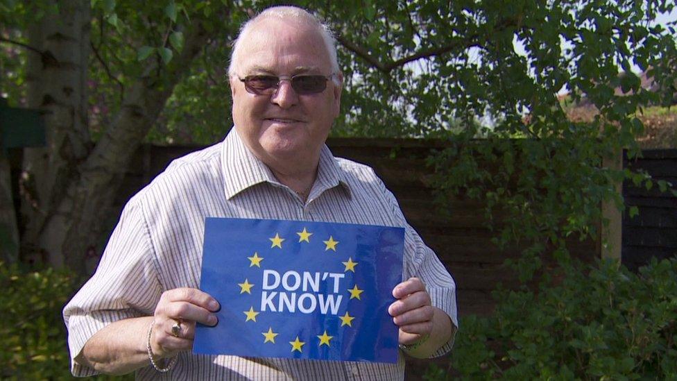 Raymond Dormer holding a don't know sign