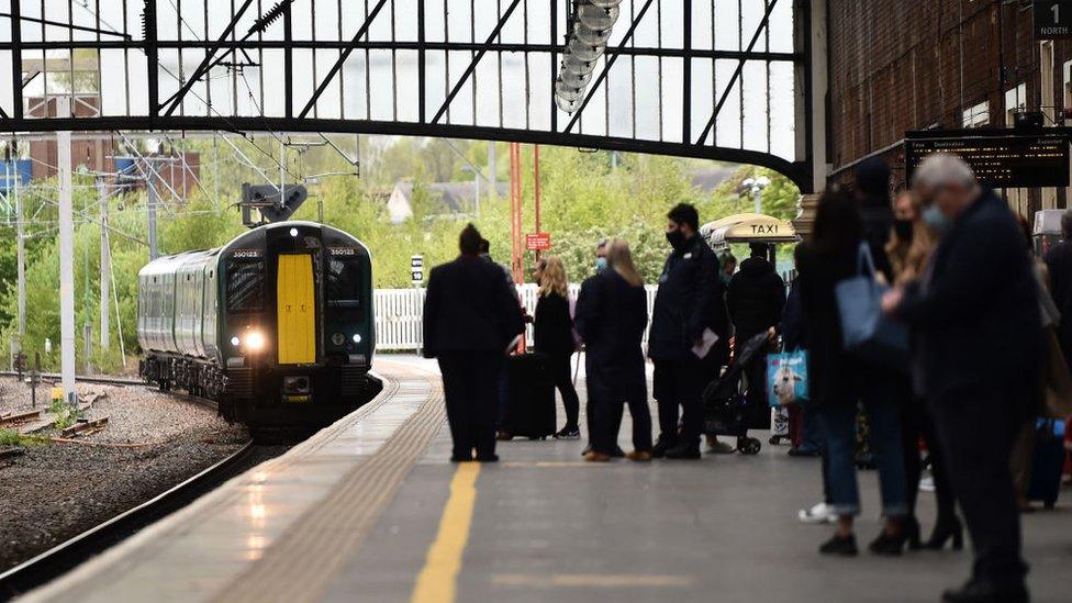 Travellers waiting for a train at the station