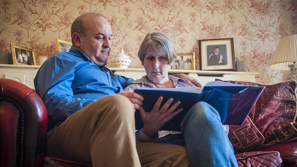 Ray and Alison Johnson at home in Wisbech. Elliott's graduation photograph sits behind them on the mantelpiece