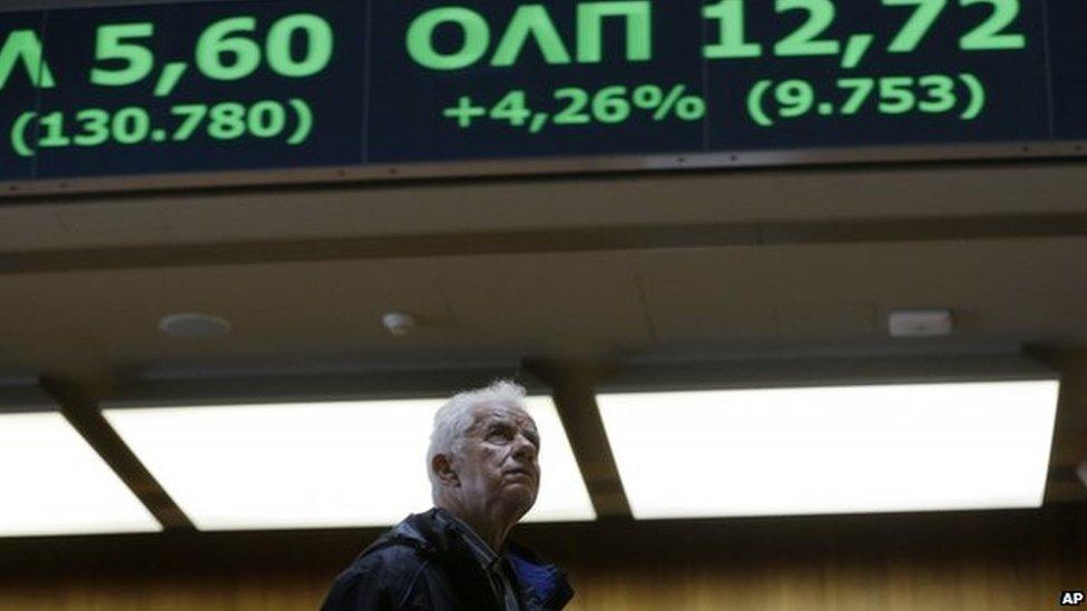 An elderly man looks at rising stocks in green at the Stock Exchange in Athens on Monday, June 22, 2015