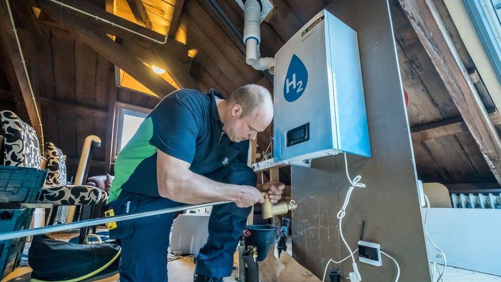 A man fitting a hydrogen boiler