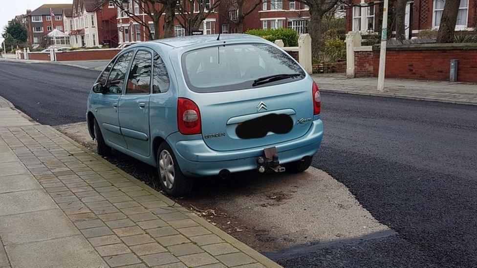 Car surrounded by road surface Southport