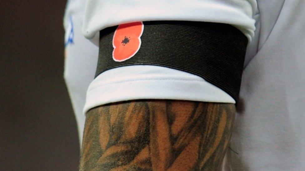 England's Glen Johnson displays a poppy on an armband during the international friendly match between England and Spain in 2011