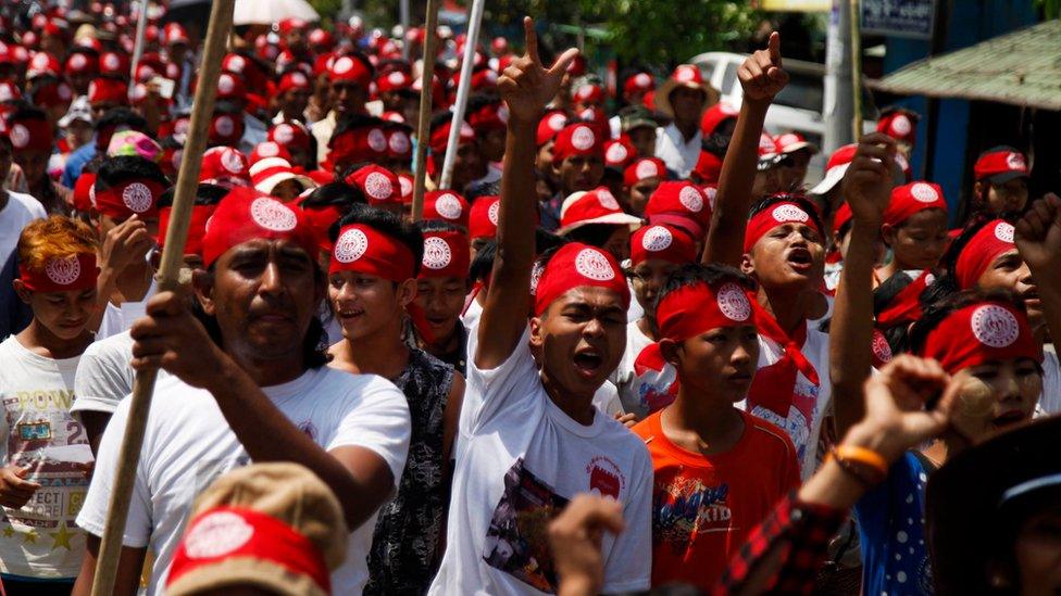 People hold posters and shout slogans as they march during a protest held to show opposition to the government of Myanmar's plan to give citizenship to some Rohingya Muslims, in Sittwe, Rakhine State