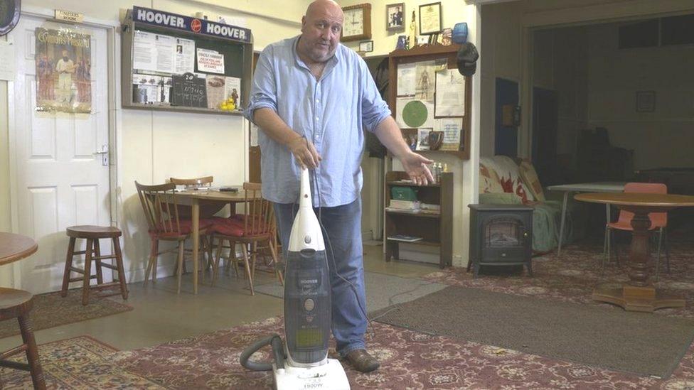 Steve Speirs with a vacuum cleaner on a film set