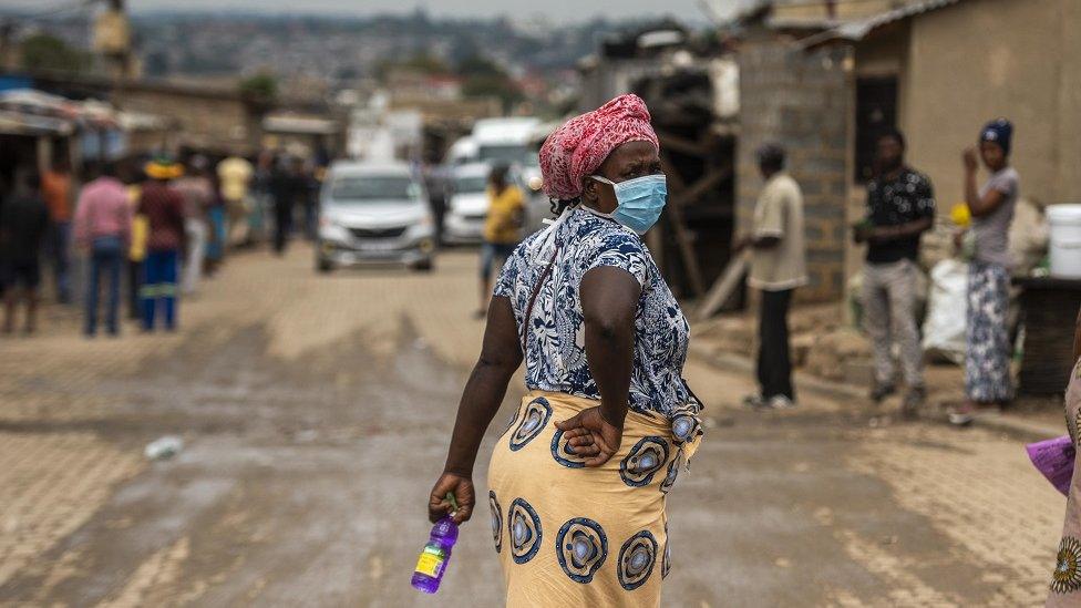 A woman wears a mask in Alexandra, South Africa.