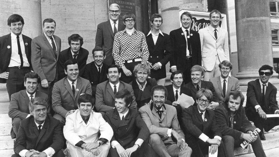 Disc Jockeys outside All Souls as BBC Radio 1 (Radio One) and Radio 2 (Radio Two) networks announce their line-ups near Broadcasting House, September 4th 1967. (front row l-r) Pete Murray, Ed Stewart, Pete Drummond, Mike Raven, Moke Ahern and John Peel. (Middle row l-r) Bob Holness, Terry Wogan, Barry Alldis, Mike Lennox, Keith Skues, Chris Denning, Johnny Moaran and Pete Myers. (Back row l-r) Tony Blackburn, Jimmy Young, Kenny Everett, Duncan Johnson, Robin Scott (controller), David Ryder, Dave Cash, Pete Brady and David Symonds.