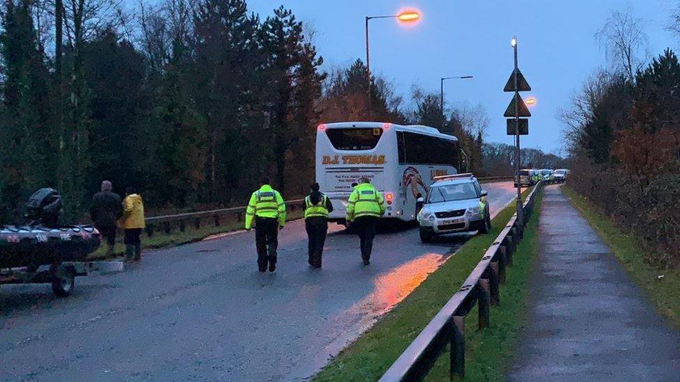 Bus evacuating residents of Tonna near Neath