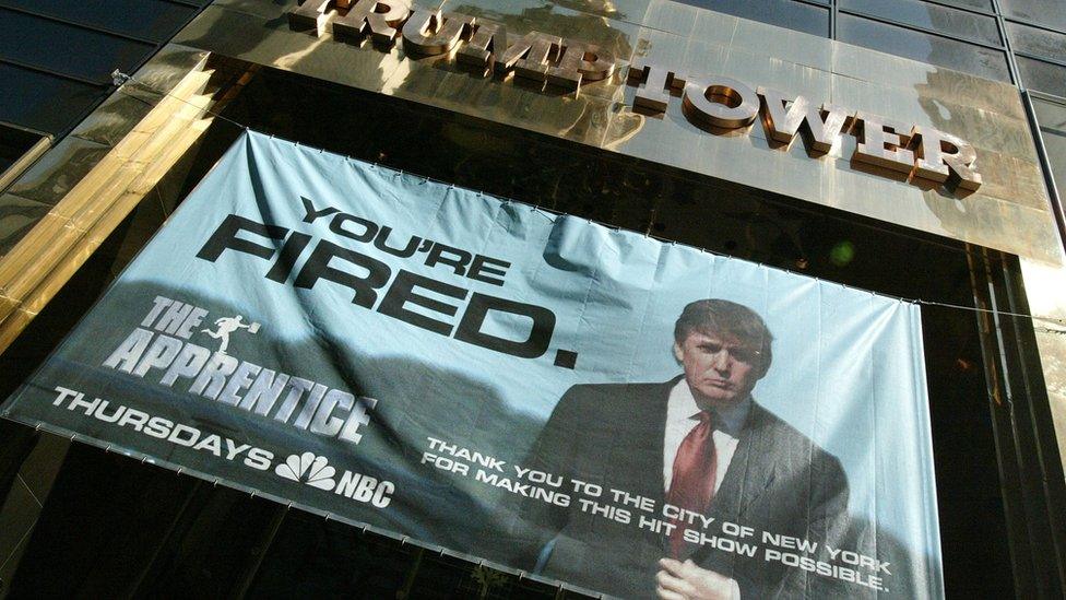 A sign with the slogan YOU'RE FIRED advertising the American television show "The Apprentice" starring Donald Trump hangs at Trump Towers April 15, 2004 in New York City