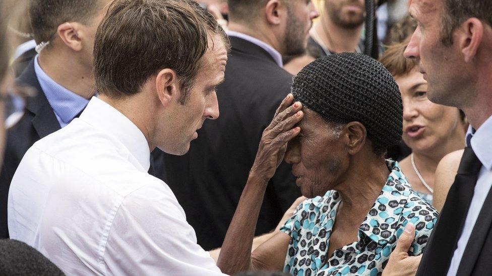 French President Emmanuel Macron speaks with a resident on the French Caribbean island of Saint-Martin, 29 September 2018