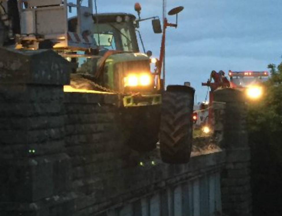 Tractor embedded in bridge