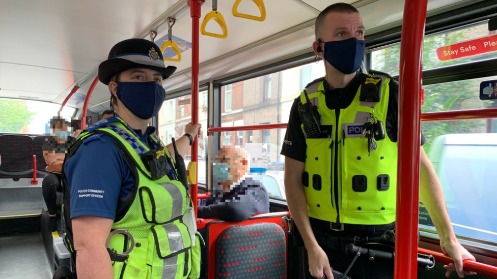 Police officers on a bus