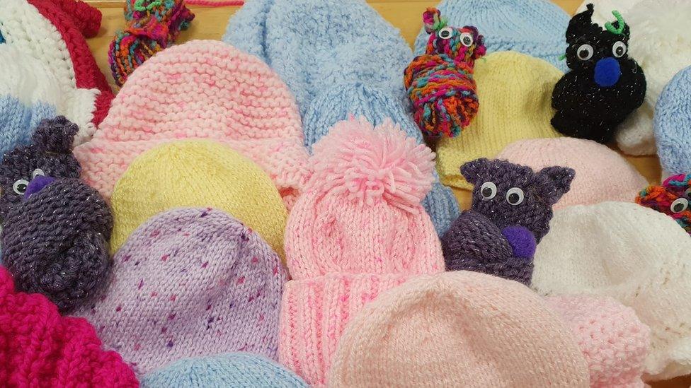 cardigans and hats knitted for refugees by Action Mental Health in Derry