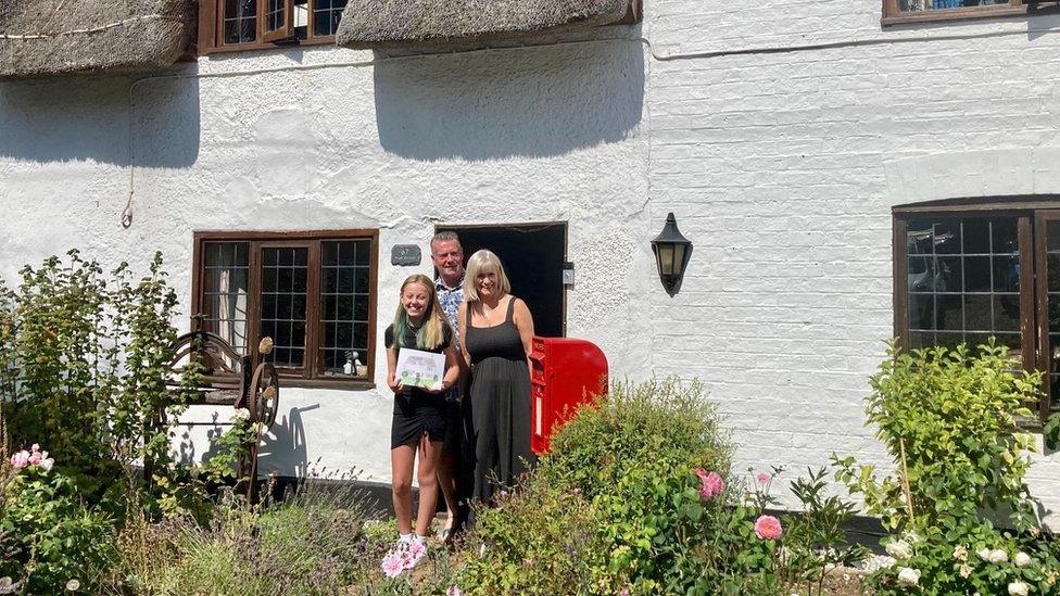 Alice outside a house with Suzette Lightning and Mark Steadman, in Riseley, Bedfordshire