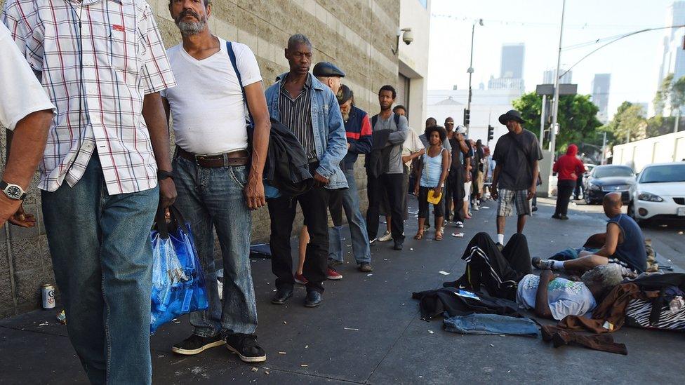 People wait for a meal outside the Midnight Mission on Skid Row in Los Angles, California, September 23, 2015