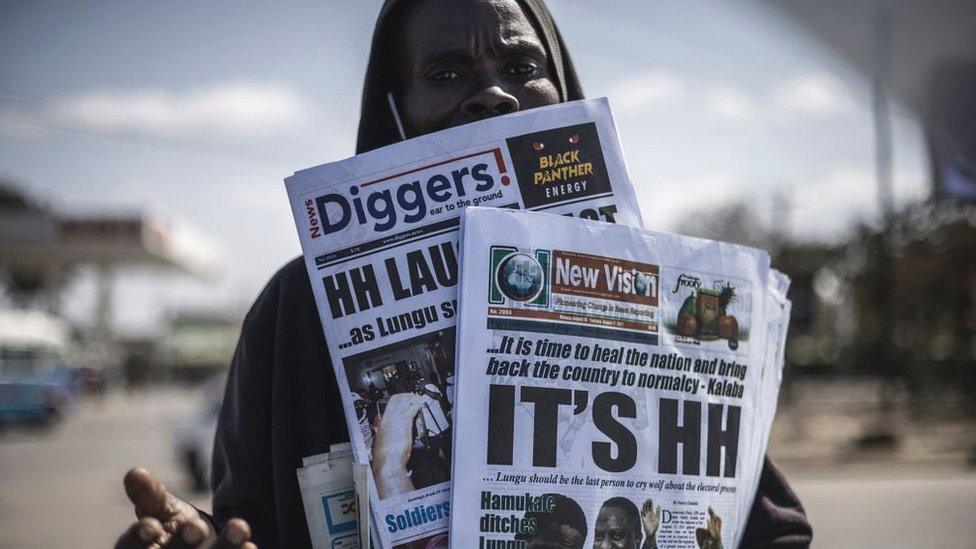 A newspaper vendor is seen carrying today's Zambian dailies in Lusaka, August 2021