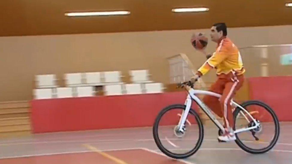 Kurbanguly Berdymukhamedov playing basketball on a bicycle