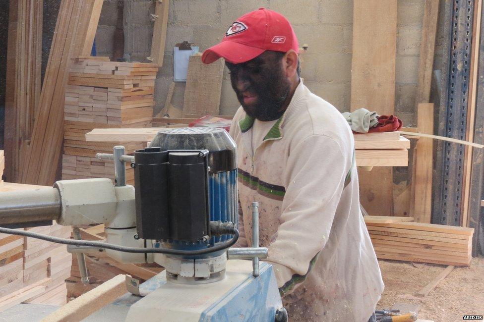 Aceves working in a lumber yard