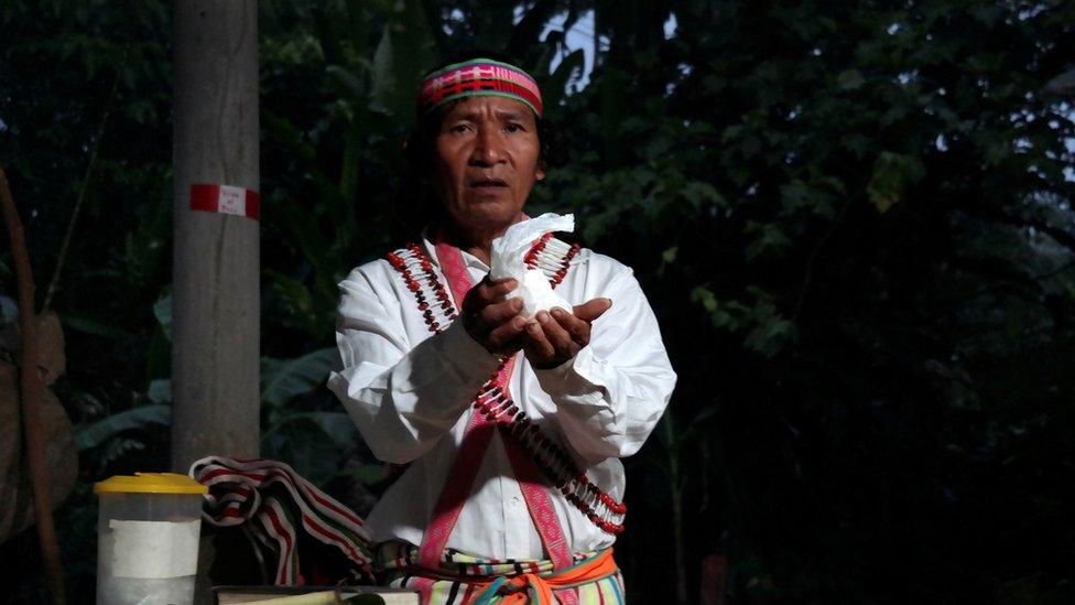 Shainkiam Yampik Wananch, a deacon ordained by the Catholic Church, holds up a host during a liturgy with indigenous Achuar people at a chapel in Wijint, a village in the Peruvian Amazon, Peru August 20, 2019.