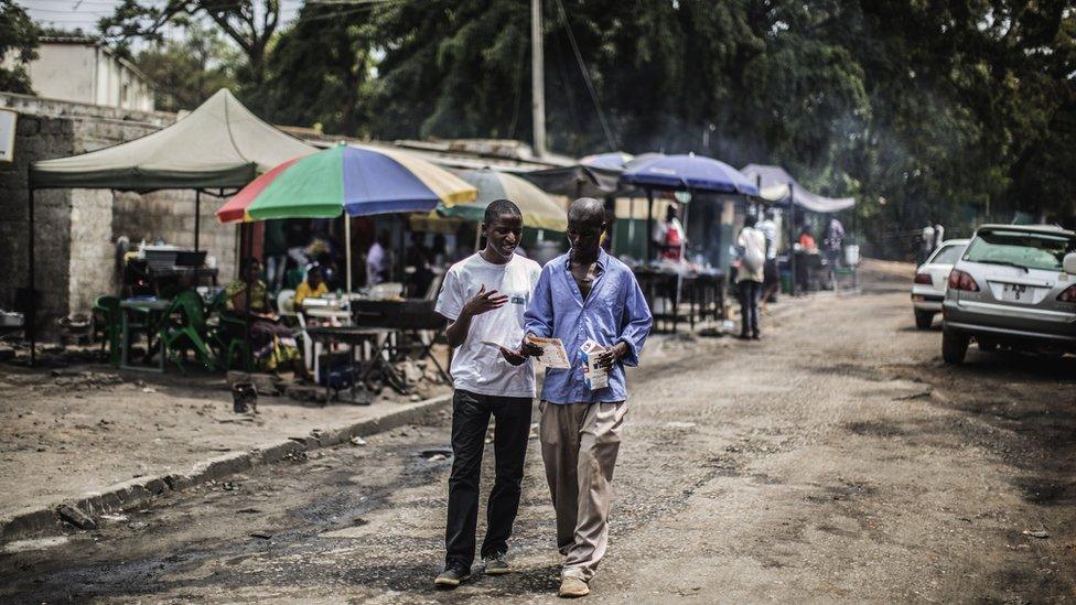 A youth activist distributes leaflets about HIV counselling services in Lusaka, Zambia - 2014